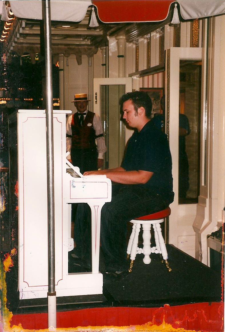 15-Year Old Jonny May playing the Coke Corner Piano at Disneyland with teacher Johnny Hodges watching - Year 2002